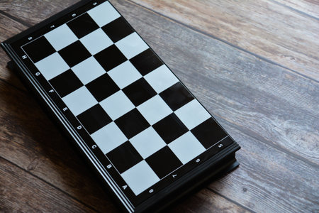 Chessboard on a wooden table. Top view with copy spaceの写真素材