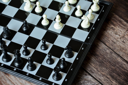 Chess pieces on a chessboard. Black and white background.の写真素材