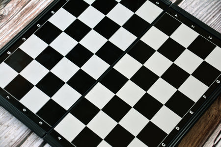 Chess board on a wooden background. Black and white chessboardの写真素材