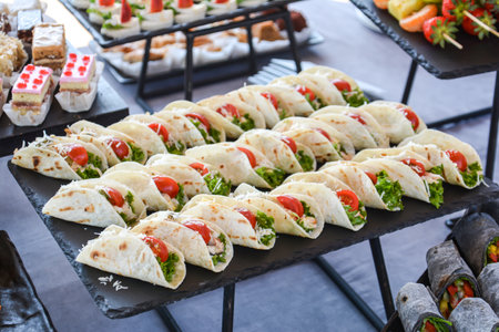 Catering buffet with variety of food snacks and appetizers.