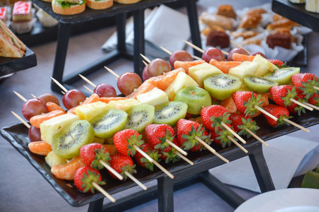Fruit skewers on a buffet table at a wedding party.の写真素材