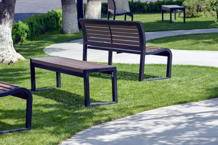 Wooden bench in the park on a sunny day. Nobody insideの写真素材