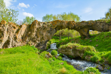 Old stone bridge over a small river in the spring forest. Spring landscapeの写真素材