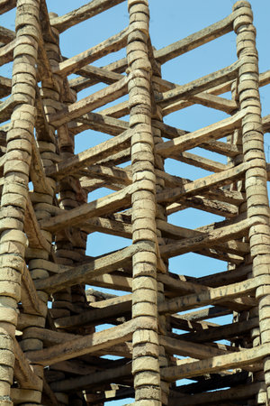 Wooden scaffolding with blue sky in background, closeup of photoの写真素材