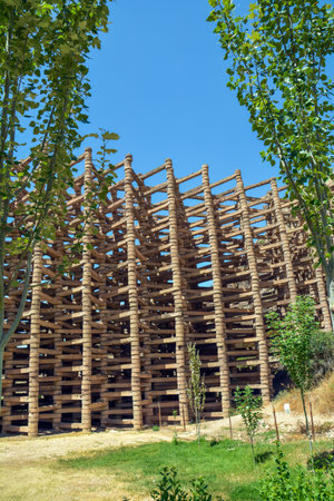 Wooden scaffolding on the background of green trees and blue skyの写真素材