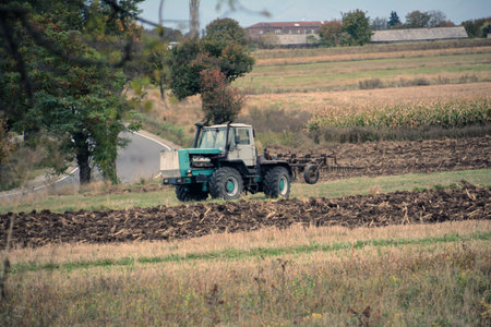 Agricultural tractor plowing the field in autumn. Toned.