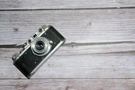 Vintage camera on wooden background. Top view with copy space.の写真素材