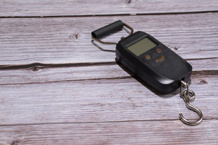 A black scale on a wooden table.の写真素材