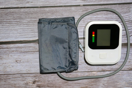 Electronic blood pressure monitor with pulse oximeter on wooden background.の写真素材