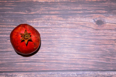Ripe pomegranate fruit on wooden background. Top viewの写真素材