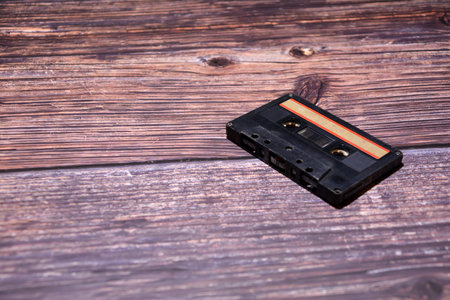 Vintage audio cassette tape on wooden background. Retro music concept.の写真素材