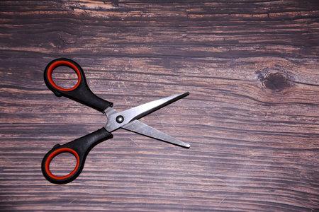 Scissors on a wooden background. Top view. Copy space.の写真素材