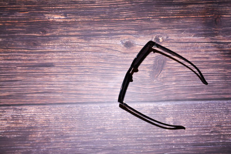 Eyeglasses on wooden background with copyspace for text.の写真素材