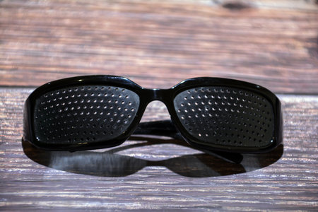 Glasses with perforation. Glasses for vision with holes. Perforated training glasses. Glasses with holes for improved vision.の写真素材