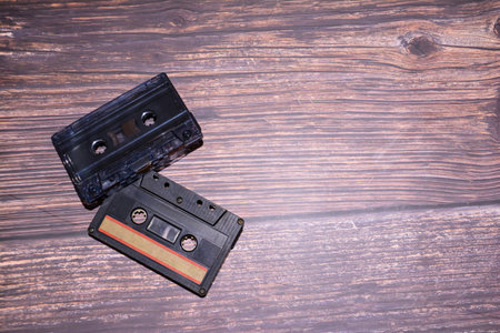 Vintage audio cassette tape on a wooden background. Retro music concept.の写真素材