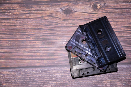 Vintage audio cassettes on a wooden background. Top view.の写真素材