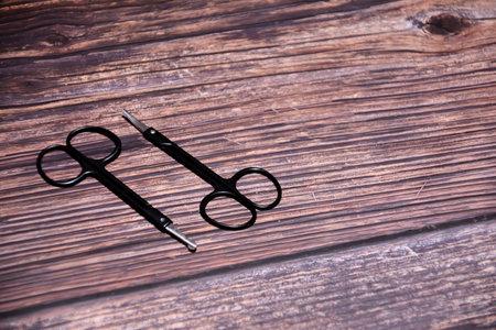 Scissors on a wooden background, close-up, copy spaceの写真素材