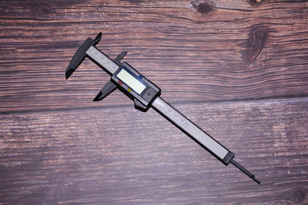 Vernier caliper on wooden background. Measurement tool.の写真素材