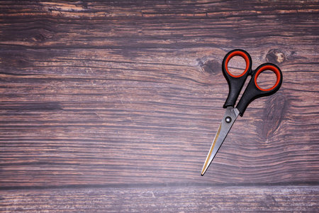Scissors on a wooden background. Top view. Copy space.の写真素材