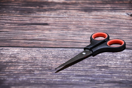 Scissors on a wooden background. Top view. Copy space.の写真素材
