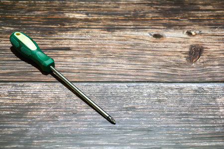 Screwdriver on wood background with space for text or image.の写真素材