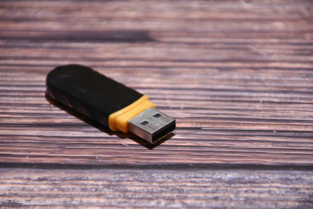 Usb flash drive on a wooden background. Selective focus.の写真素材