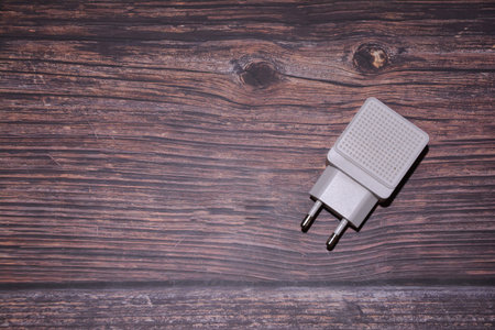 An adapter on a table. Adapter on a wooden background.