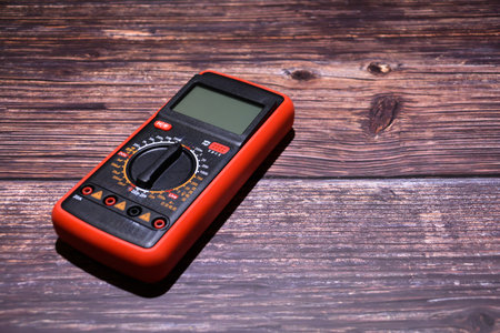 Digital multimeter on a dark wooden background. Selective focus.の写真素材