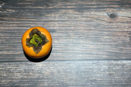 Persimmon fruit on wooden background. Top view. Copy space.の写真素材