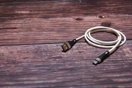 USB cable on a wooden background. Selective focus. Copy space.の写真素材