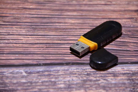Usb flash drive on a wooden background. Selective focus.の写真素材