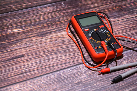 Digital multimeter on a wooden background. Multimeter on a wooden background.の写真素材