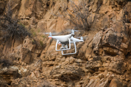 Drone flying over the rocks. Close-up of a quadcopter.の写真素材