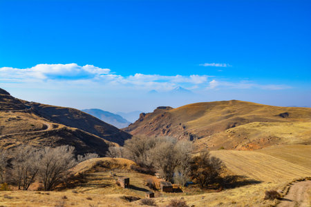 Mountain in the clouds. Beautiful mountain. Beautiful natural landscape with fields and mountains. Cloudy sky and mountain peakの写真素材