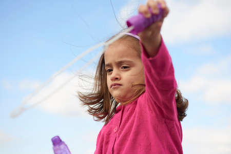 Portrait of a little sad girl in a parkの写真素材