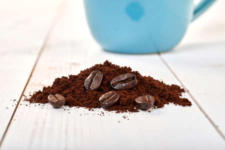 Ground coffee isolated on a wooden table