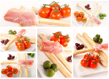 Aperitif and appetizers with breadsticks, tomatoes and olivesの写真素材