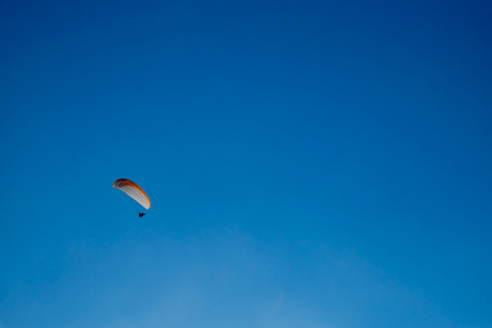 Paragliding over blue sky backgroundの写真素材