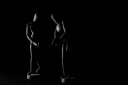 Wooden models on black background