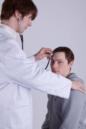A doctor examines a patient with a stethoscopeの写真素材