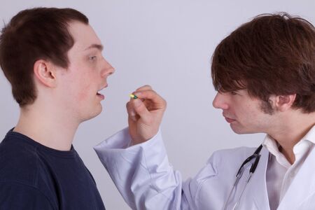 A young man gets drugs from his doctorの写真素材