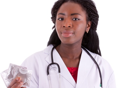 A young black woman with a condom in her handの写真素材