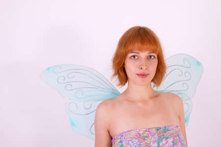 A young beautiful woman with wings in front of the cameraの写真素材
