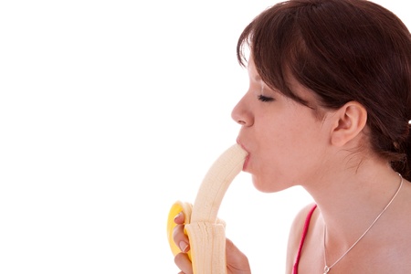 The pretty young woman has a banana in his handの写真素材