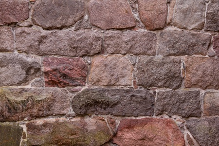 An old wall with a big boulder