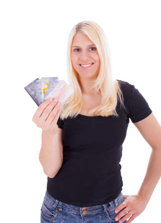 A young woman is holding credit cards in her handの写真素材