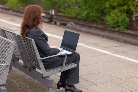 A young business woman is waiting for her trainの写真素材