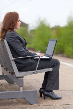 A young business woman is waiting for her trainの写真素材
