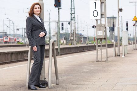 A young business woman is waiting for her trainの写真素材