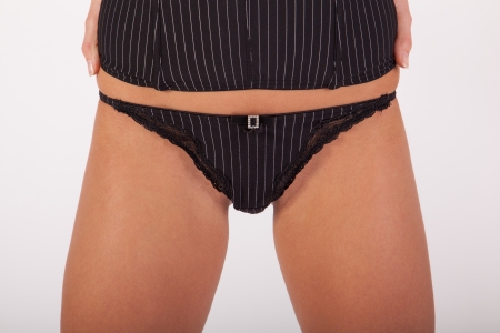 A young girl in lingerie is standing in front of a cameraの写真素材